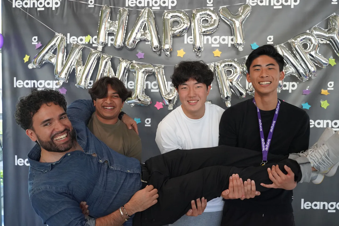 Leangap students lifting Sadok Cervantes at the Leangap anniversary party