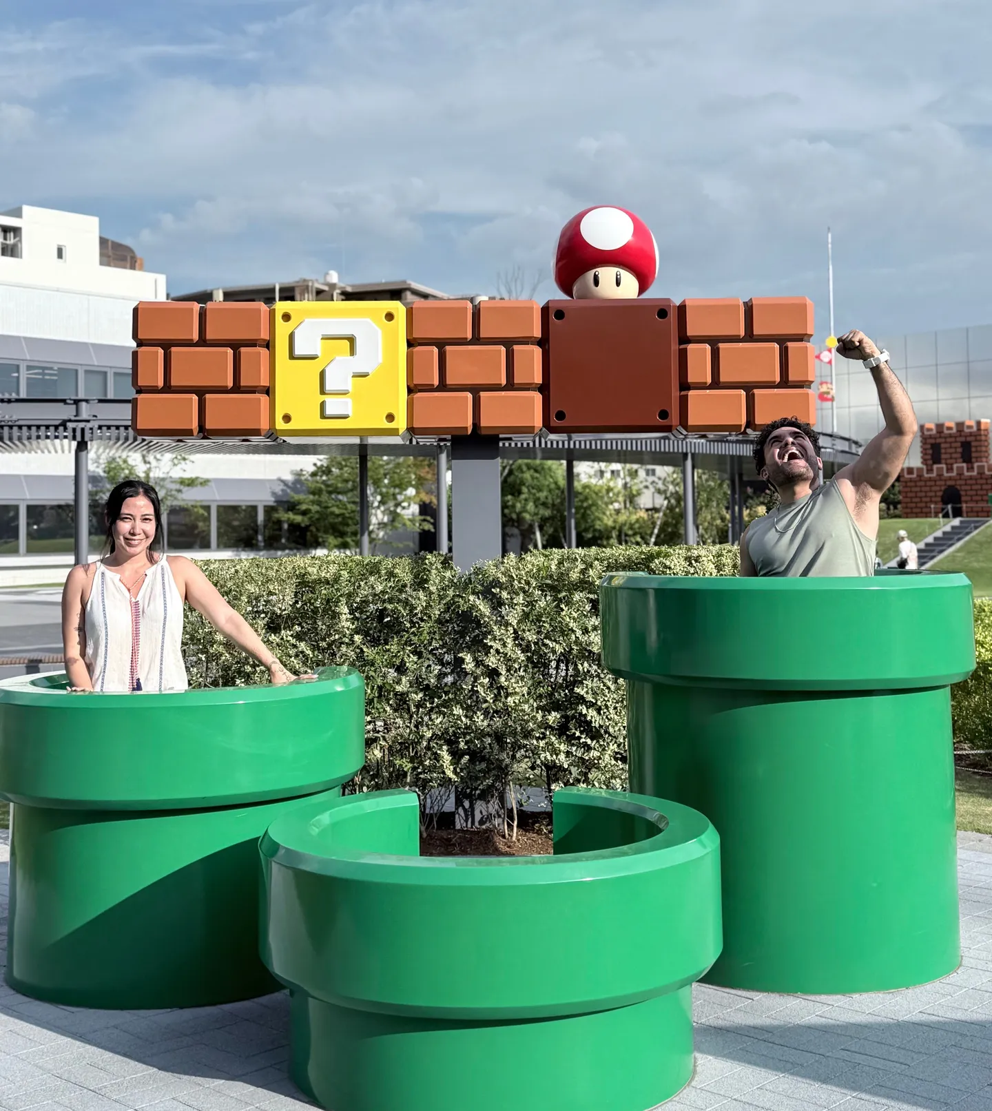 Sadok Cervantes at a Super Mario installation of green pipes and a question block
