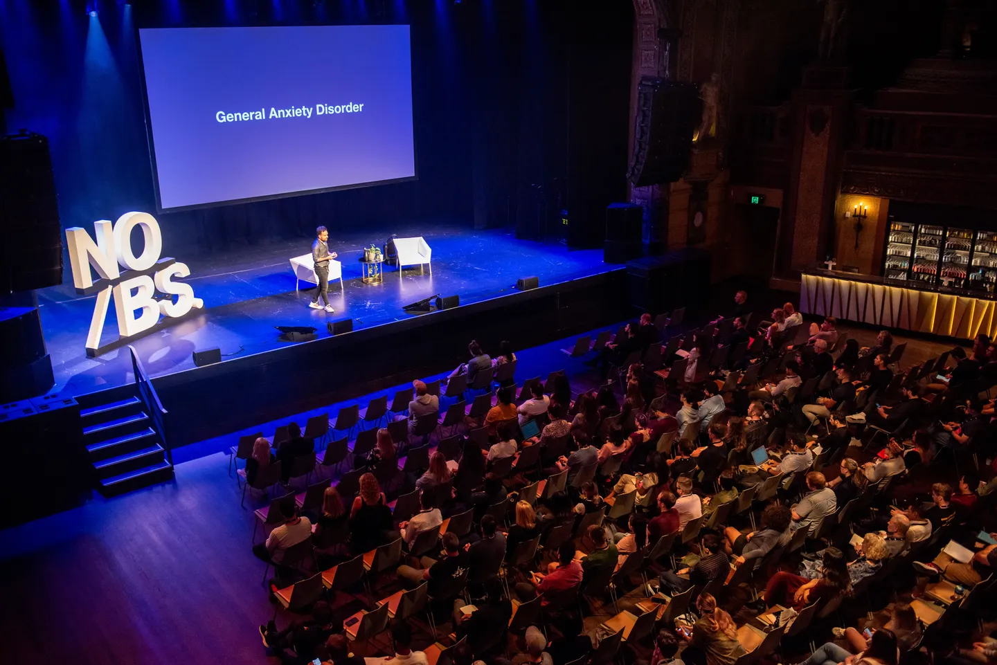 A full auditorium facing the NO/BS. stage